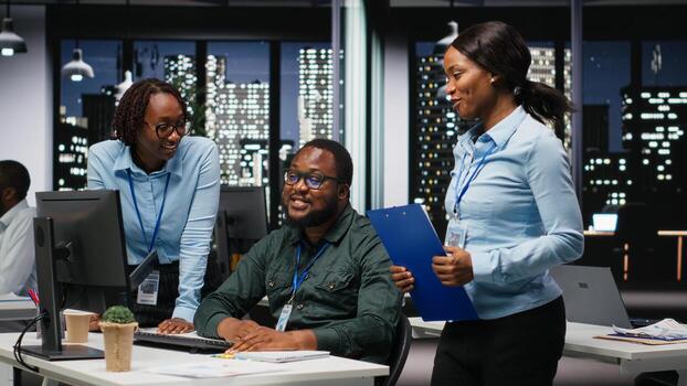 African american analysts collaborating on a project with financial forecasting, projecting data to expand the enterprise activity and profit. Teamwork in workspace to ensure objectives. photo
