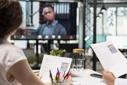 Human resources diverse team chatting with applicant via online call interview, engaging in a web chat with HR to discuss job application details and potential onboarding. Head hunting. photo