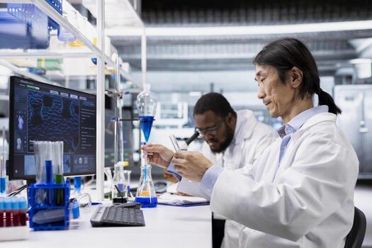 Clinical microbiologist using PC, looking at 3D molecular model. Research facility professional using bioengineering program on computer monitor in medical lab displaying DNA data photo