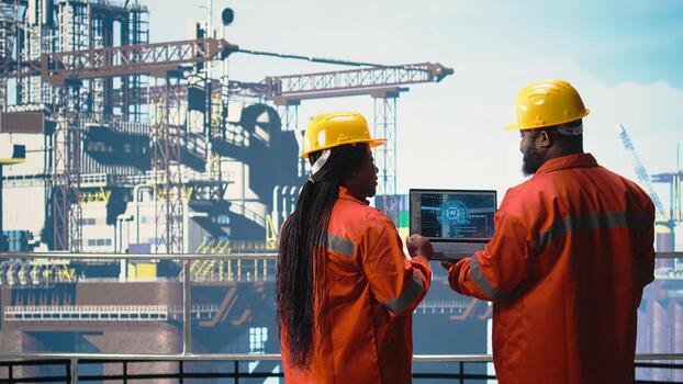 Offshore rig technicians using neural network AI LLM chatbot to improve drilling accuracy. Engineering team uses artificial intelligence machine learning model to prevent malfunctions, photo