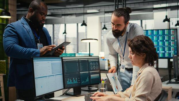 Professional colleagues team analyzing online graphs and resource allocation, demonstrating engagement and synergy between coworkers as they prepare performance reports. Networking. photo