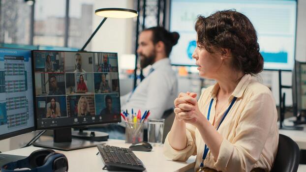 Woman engaging in discussion on call to share finance strategy details, using data analysis to create a briefing for reports. Building an effective partnership via conferencing. Camera B. photo