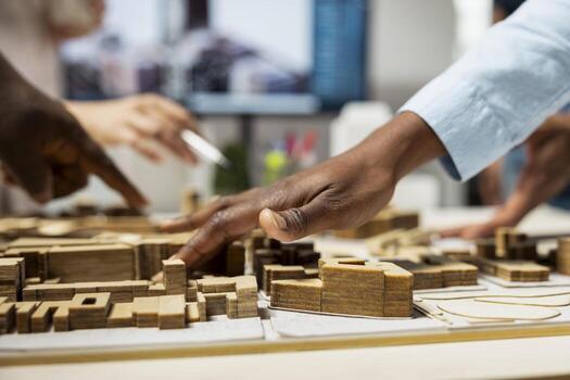 Close up of real estate team creating the layout for a residential area, simulating site preparation with 3D models before the project approval. Modern infrastructure city planning. photo