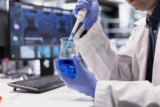 Close up of male chemist does experiment with pipette and jar, extracting tissue and mixing DNA compound in laboratory. Molecular science and biochemistry through scientific method. photo