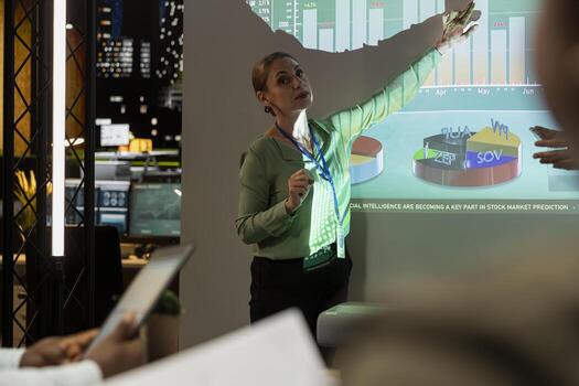 General director showing statistics data on projection board in a conference, overview meeting with specialists for a presentation. Workmates studying reports to adapt within market conditions. photo