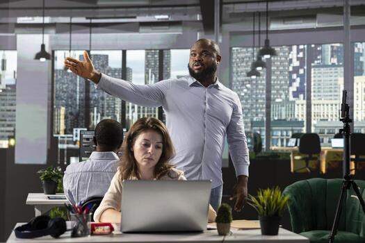 Diverse professionals collaborating on business planning and analytics, reviewing visual data and projections to support strategy and progress within multinational company. Briefing. photo