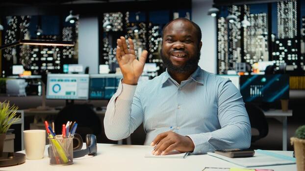 African american male advisor joining a web call on laptop, engaged in discussion after hours. Professional man interacting with shareholders, adaptability in networking session. photo