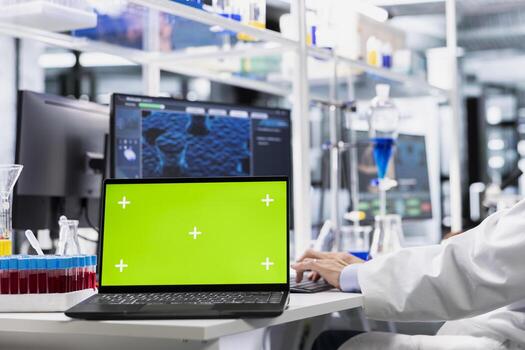 Close up of isolated screen laptop used by lab expert doing genetics study using clinical equipment. Scientist using scientific gear at workbench, doing complex experiments with chroma key notebook photo
