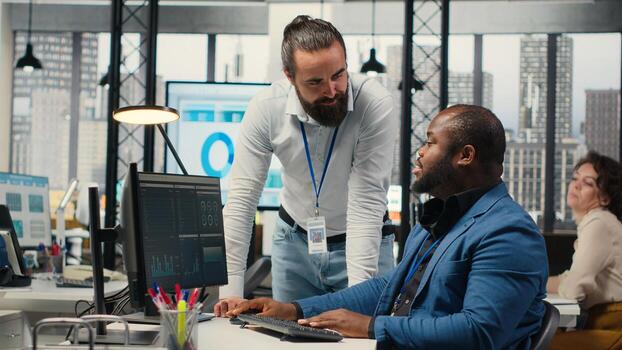 Administrator and assistant gather data from monthly reports, reviewing performance metrics and creating graphs that align with project goals. Teamwork for innovation and achievement. Camera B. photo