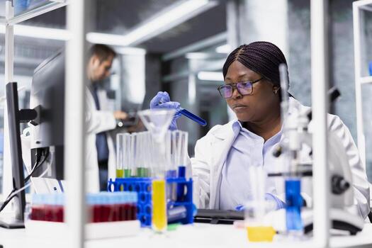 African american expert working for bioscience with modern lab tools, conducting experiment and reviewing DNA tissue for biotechnology research study, advanced testing in laboratory. photo