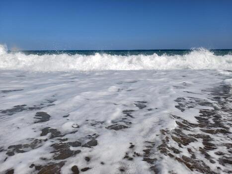 sea foam details, calm tide with delicate foam, receding tide forms intricate foam patterns photo