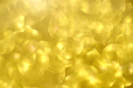 Shimmering golden bokeh background with abstract light patterns and soft glowing effect. photo