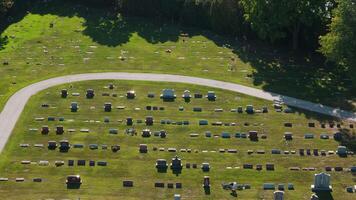 A drone view showing rows of tombs with variety of monuments, place of sorrow and memory. Cemetery on sunny day video