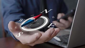 Concept of business direction and digital strategy with a 3D compass floating above a businessman hand, symbolizing leadership, decision making, innovation, and navigation in modern technology video