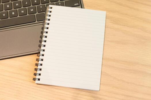 Blank Notebook on Wooden Desk with Laptop. concepts to work, study, planning, writing, journaling, or creative brainstorming in a cozy workspace. photo