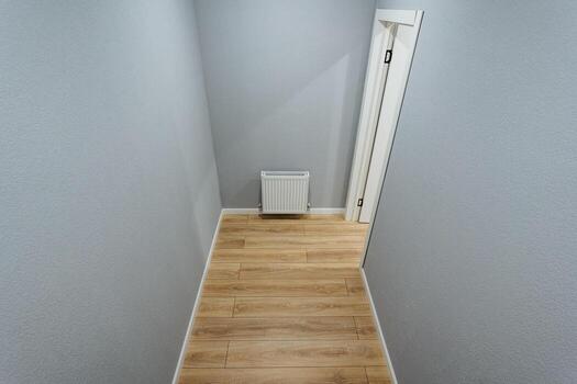 compact utility nook with heating, narrow utility alcove featuring radiator panel and inspection hatch, efficiently designed utility niche optimized for space with radiator and inspection photo