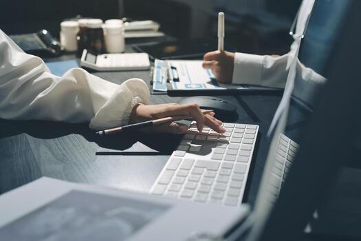 A person typing on a keyboard and using a computer photo