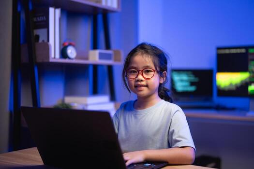 Young Girl with Glasses Engaged in Computer Programming in Modern Room with Blue Lighting and Tech Gadgets photo