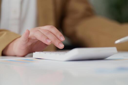 Data Entry. Close-up of a hand using a calculator for financial calculations. photo
