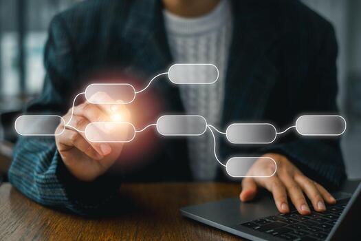Business professional using a digital flowchart on a laptop to illustrate workflow and process management. photo