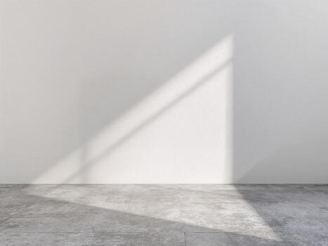 An empty room with a white wall, a concrete floor, and a soft shadow from a window. A minimalist background. photo