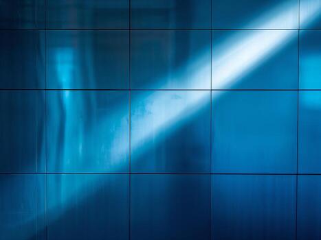 An abstract technology background with a blue, glossy tiled surface and a bright reflection of light. photo