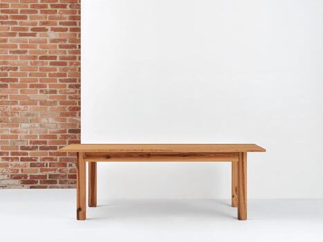 A blank wooden table in front of a white wall with a rustic brick wall border. A simple and warm mockup for product display. photo