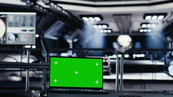 Mockup notebook used for orbital navigation data in cockpit during red planet journey. Green screen laptop used for operating spacecraft control interface next to monitor displaying Mars dashboard video
