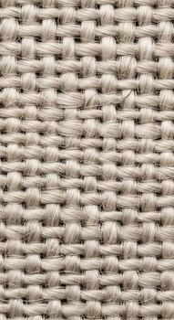 Close up view of a textured woven fabric with a natural neutral color palette and a visible weave pattern photo
