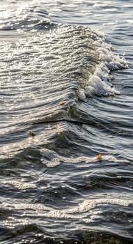 Close up abstract view of shimmering water surface with gentle ripples and light reflections creating a textured natural pattern photo