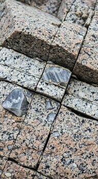 Close up view of weathered granite rock with distinct mineral veins and a small crystal fragment embedded within its textured surface photo