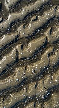 Abstract close up view of textured layered earth with distinct parallel striations and small scattered pebbles creating a natural organic pattern photo