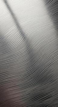 Close up abstract view of a textured metallic surface with subtle light reflections and shadows creating a dynamic pattern photo