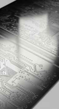 Close up abstract view of a complex printed circuit board with intricate metallic pathways and components photo