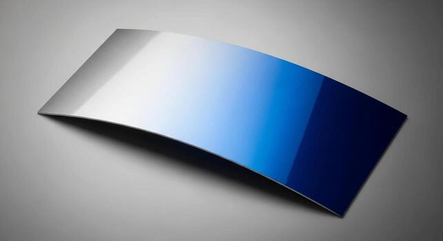 Curved metallic surface with a smooth gradient transition from bright silver to deep blue photo