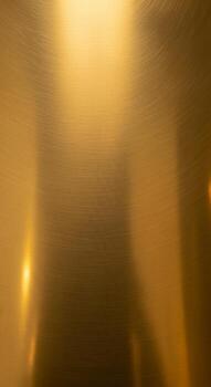 Abstract golden light streaks and reflections create a warm shimmering and luxurious background texture photo