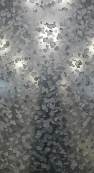 Abstract textured background with shimmering light reflections and subtle color variations creating a dynamic visual effect photo