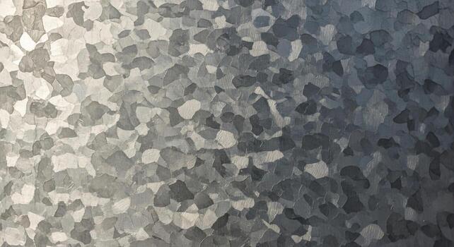 Close up abstract texture of galvanized metal with a shimmering crystalline pattern and gradient of light to dark gray tones photo