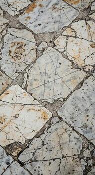 Close up of a textured stone pathway with irregular shapes and earthy tones creating a natural rustic surface photo