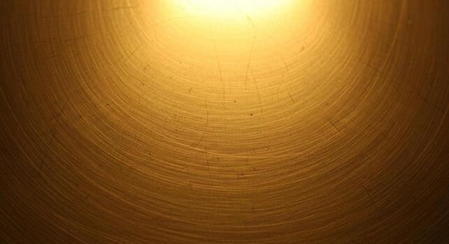 calentar dorado ligero ilumina un texturizado superficie con concéntrico circular patrones creando un radiante y atractivo resumen antecedentes foto