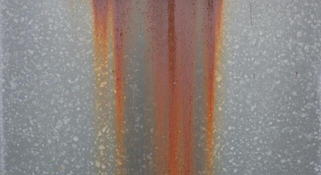 Abstract vertical composition featuring shimmering silver background with bold textured orange stripes creating a dynamic visual effect photo