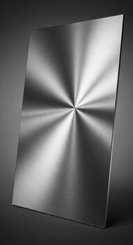 Brushed metal surface with radial pattern reflecting light and creating a starburst effect on a dark background photo