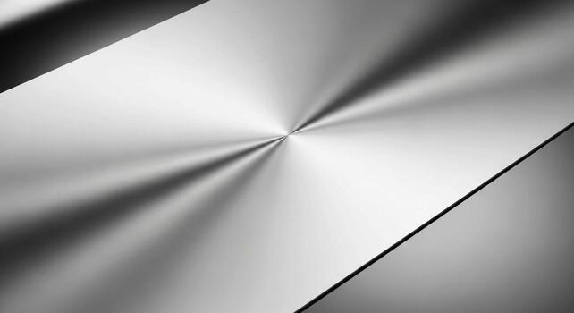 Close up of brushed stainless steel with a radial brushed pattern creating a metallic texture and reflective surface photo