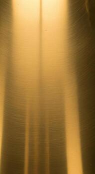 Abstract warm golden light rays streaming downwards creating a soft ethereal and glowing background texture photo