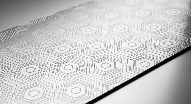 Close up of a textured surface with a repeating geometric hexagonal pattern in grayscale tones photo