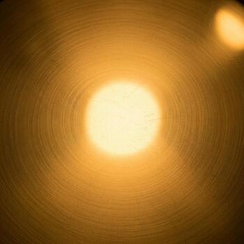 Abstract warm golden light emanating from a central bright sphere creating a soft glow and bokeh effect photo