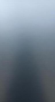 Misty blue and grey gradient sky with subtle cloud formations creating a serene and atmospheric backdrop photo