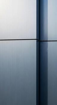 Minimalist abstract reflection of a vertical structure on a calm still body of water under a soft sky photo