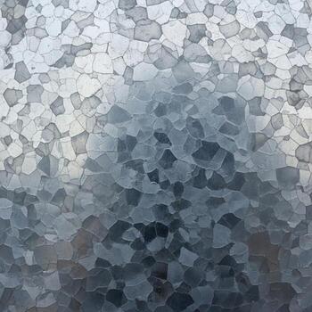 Abstract mosaic of small irregular shapes in shades of gray blue and white creating a textured dappled background effect photo