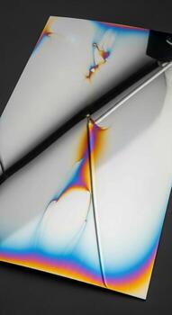 Abstract interference patterns on a folded sheet of plastic under polarized light photo